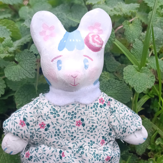 2024 handsewn bunny doll made of clay, acrylic paint, and scrap fabric.